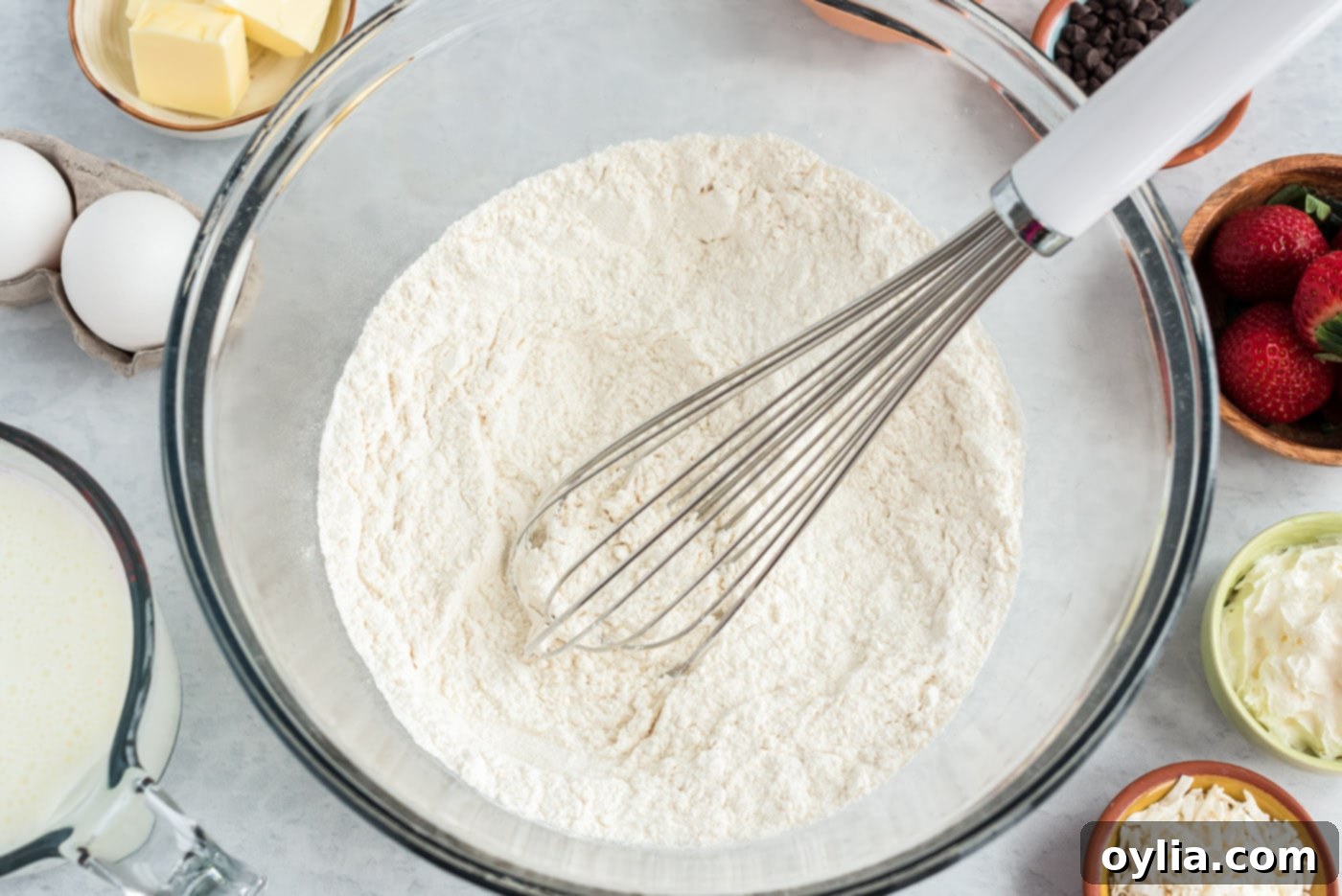 Dry ingredients for buttermilk pancakes in a bowl, showing flour, sugar, baking soda, and salt mixed together.