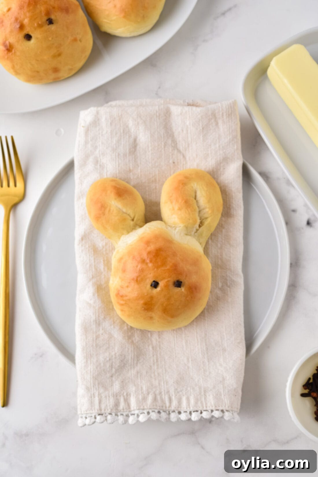 A single Bunny Roll placed on a linen napkin, acting as a charming place setting for Easter.