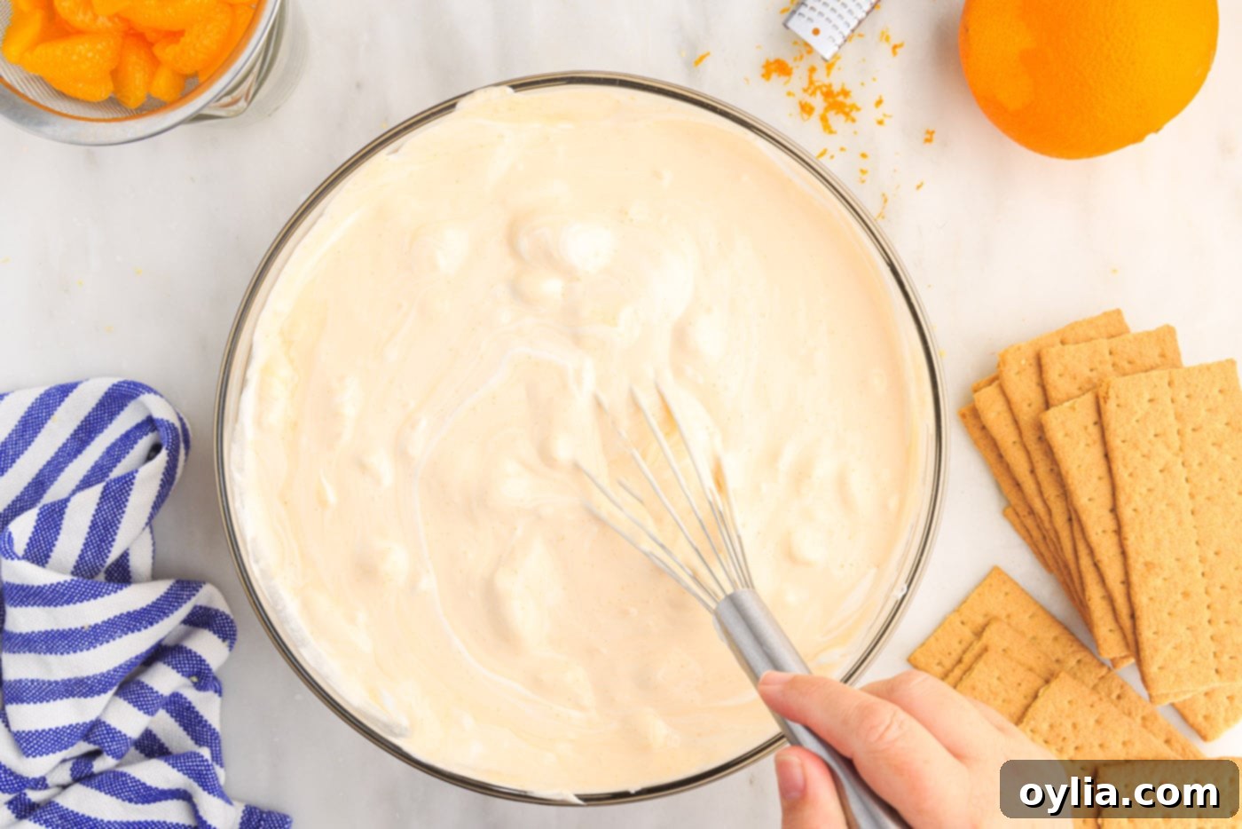 whisking orange icebox cake mixture in a bowl