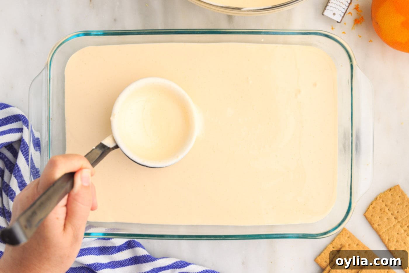 orange pudding mix over graham crackers in baking dish