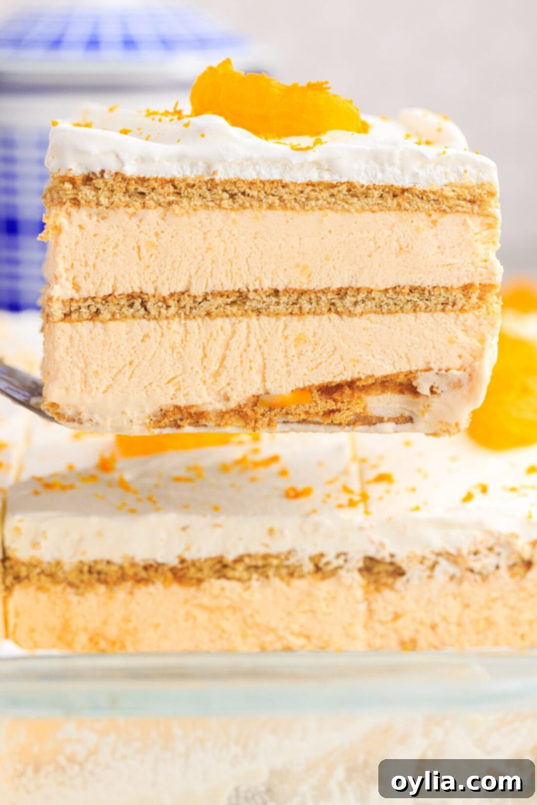 lifting a slice of Orange Icebox Cake with spatula