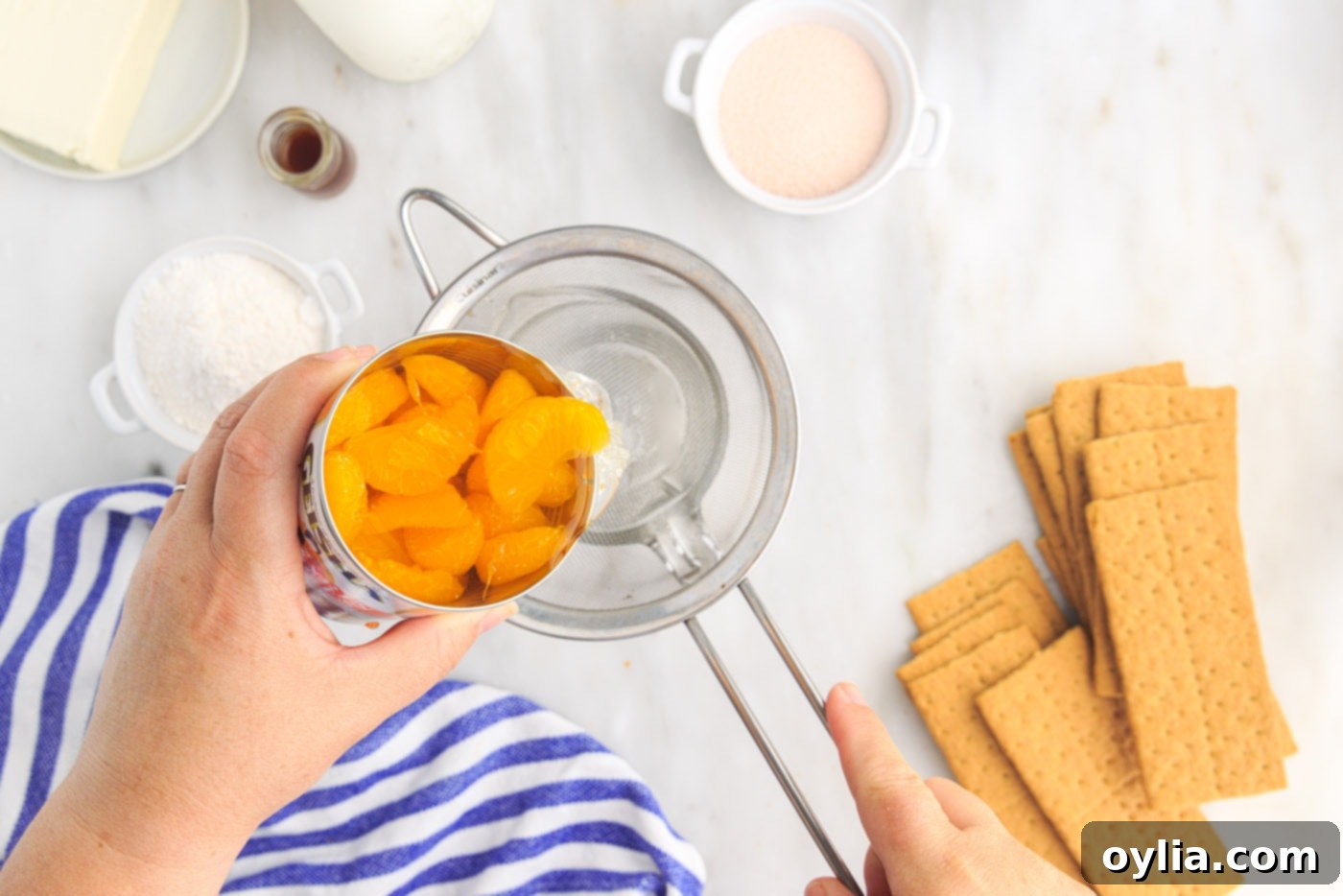 draining mandarin oranges into measuring cup