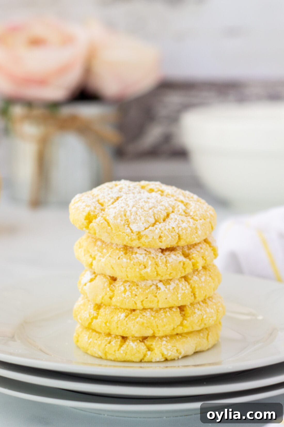 Stack of soft, chewy lemon cake mix cookies dusted with powdered sugar, perfect for a sunny day