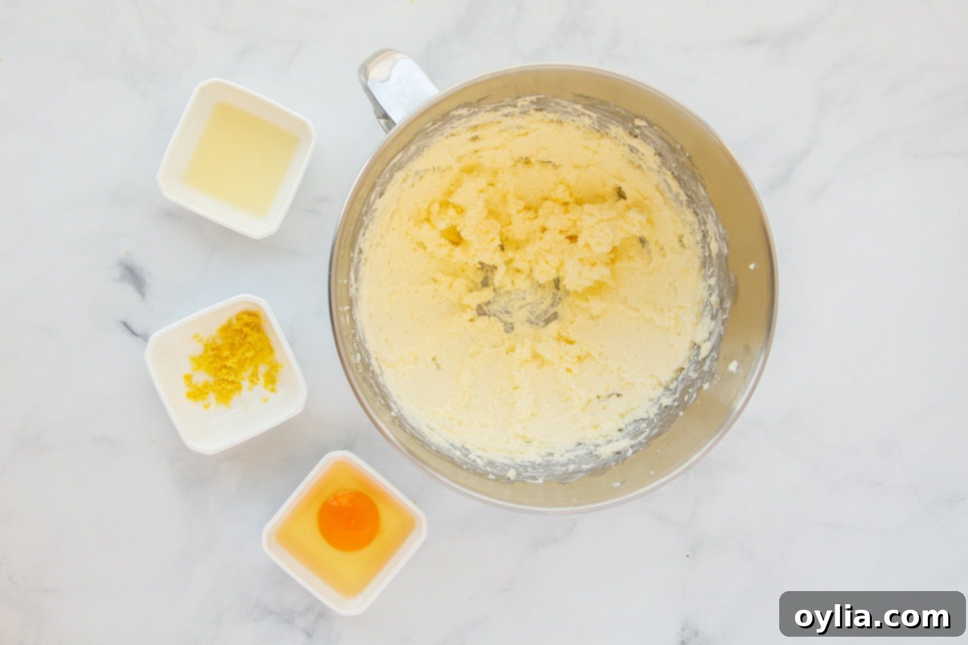 Creamy mixture of softened butter and cream cheese in a mixing bowl