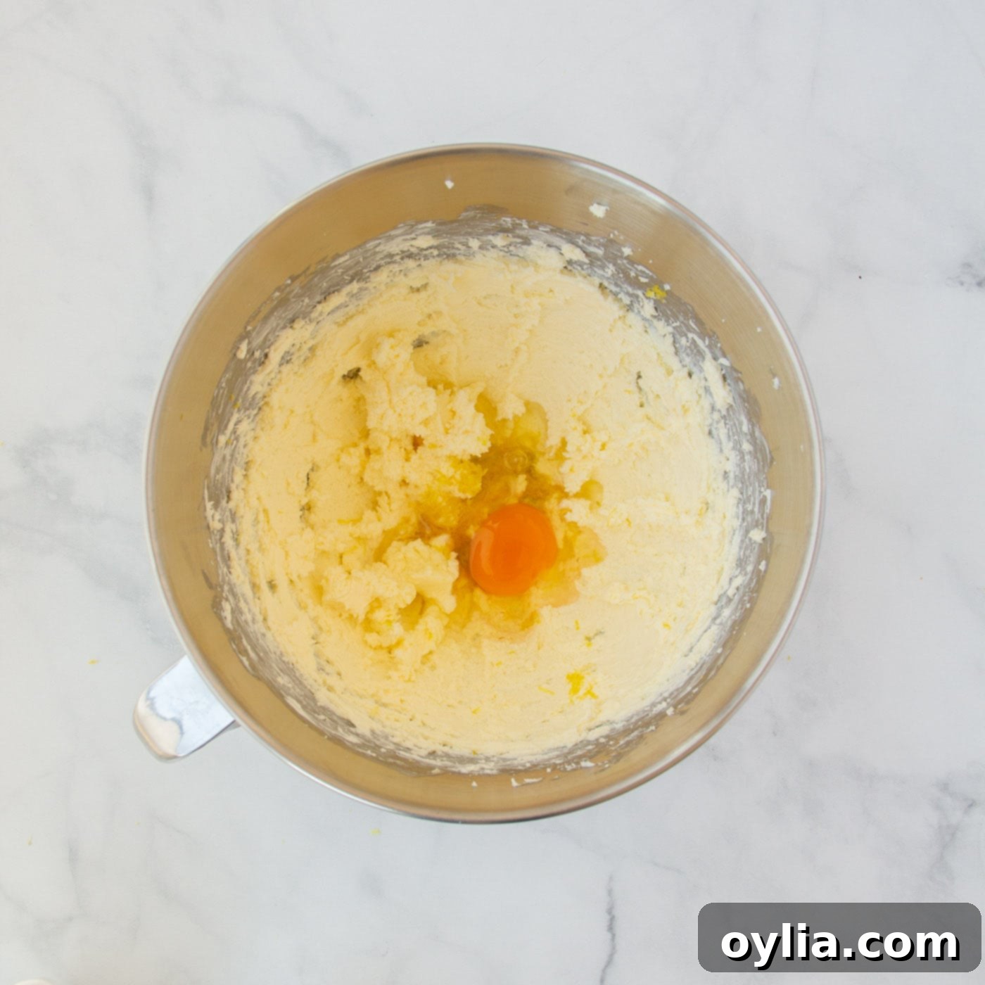 Combined lemon juice, egg, and lemon zest mixed into the cream cheese and butter base