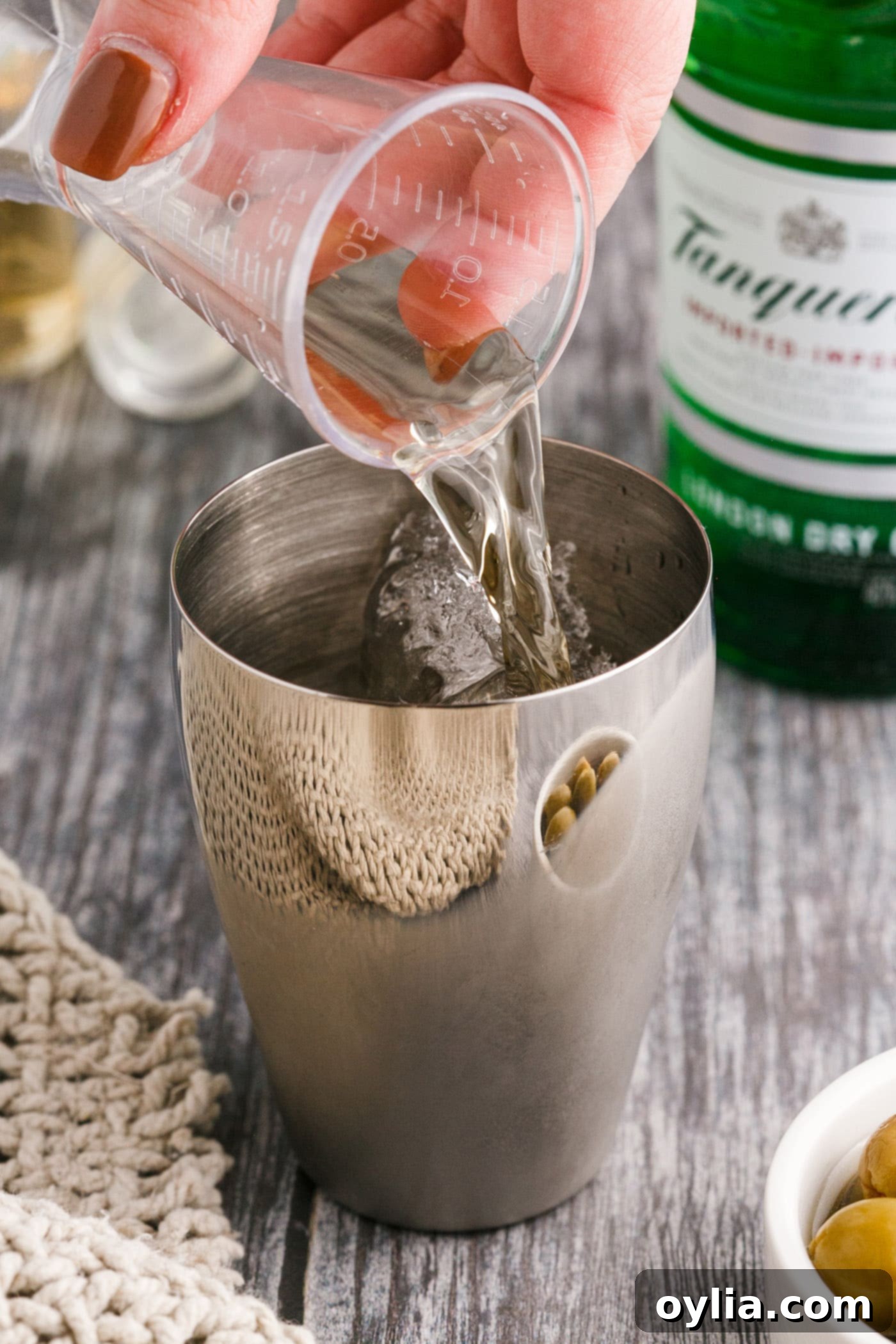 pouring gin into cocktail shaker