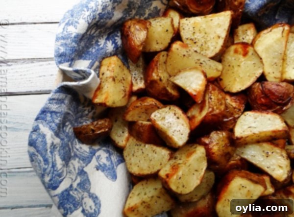 A close-up view of a perfectly portioned serving of roasted potatoes, showing their beautifully browned, slightly crispy exterior and soft texture on a white plate.