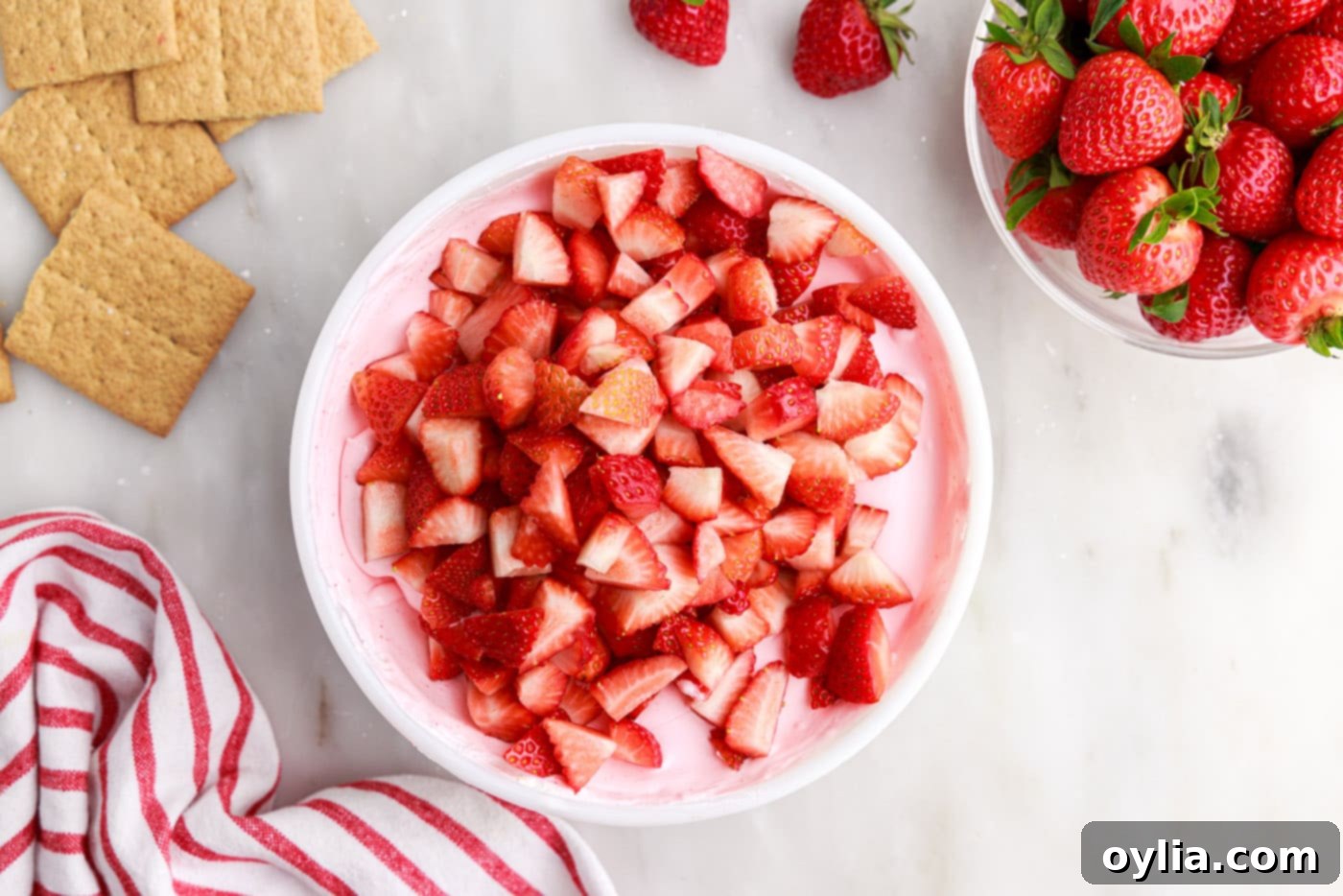 chopped strawberries over strawberry gelatin mixture
