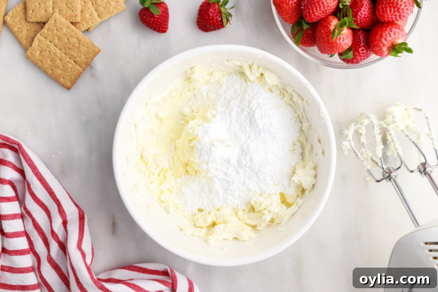cream cheese and powdered sugar in a mixing bowl