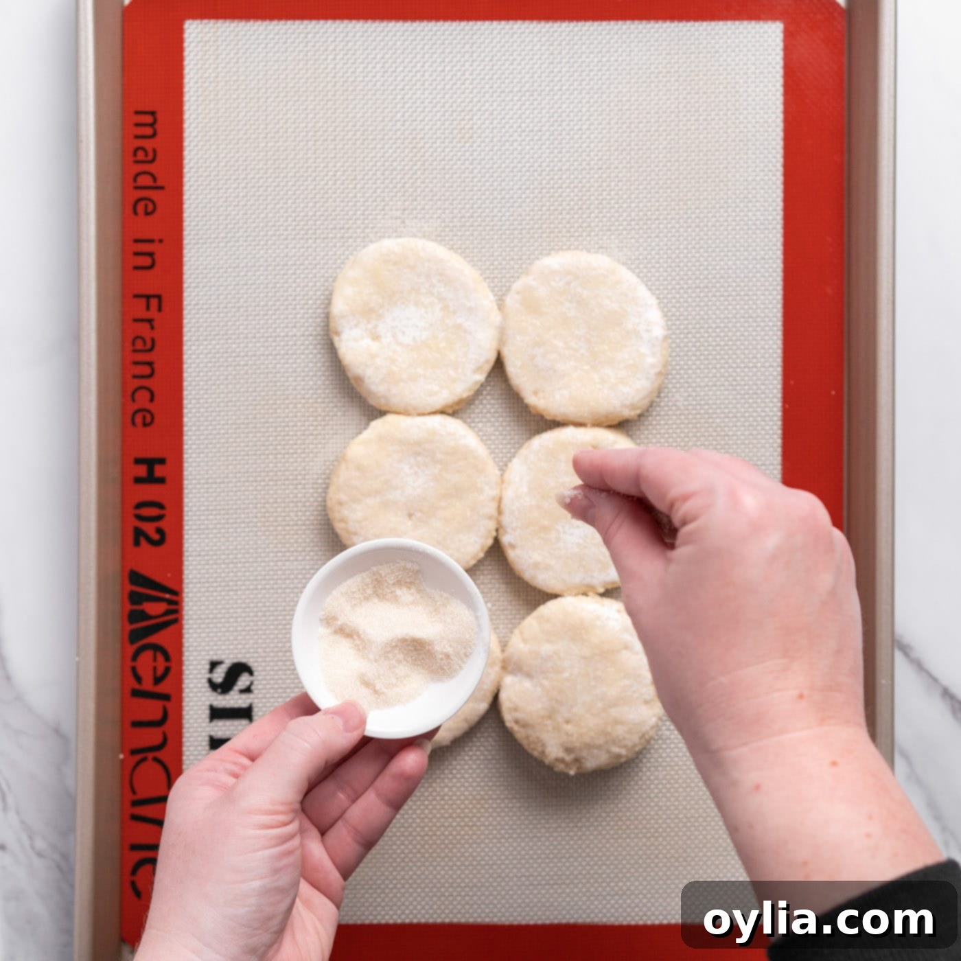 sprinkling golden sugar on biscuit dough