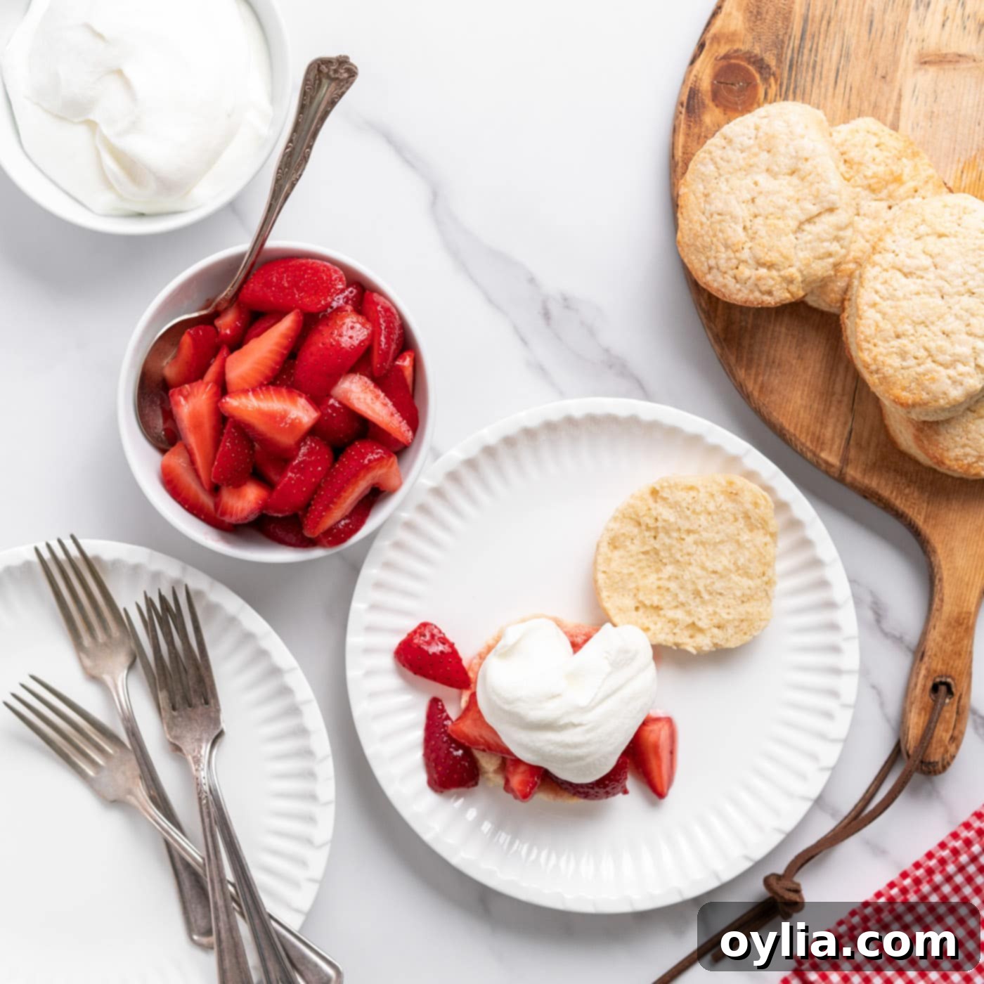 whipped cream on top of strawberries and biscuit