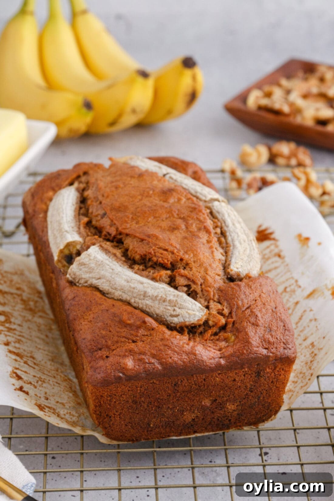 close-up of Banana Nut Bread slices with whole bananas in the background