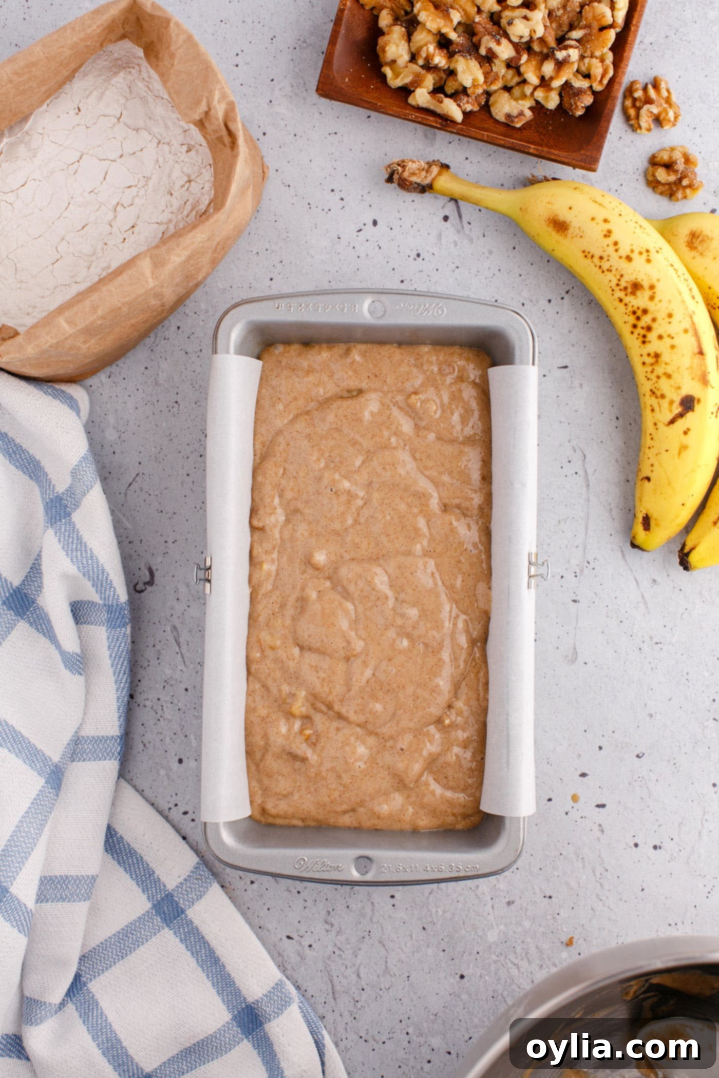 banana bread batter in a loaf pan ready for baking