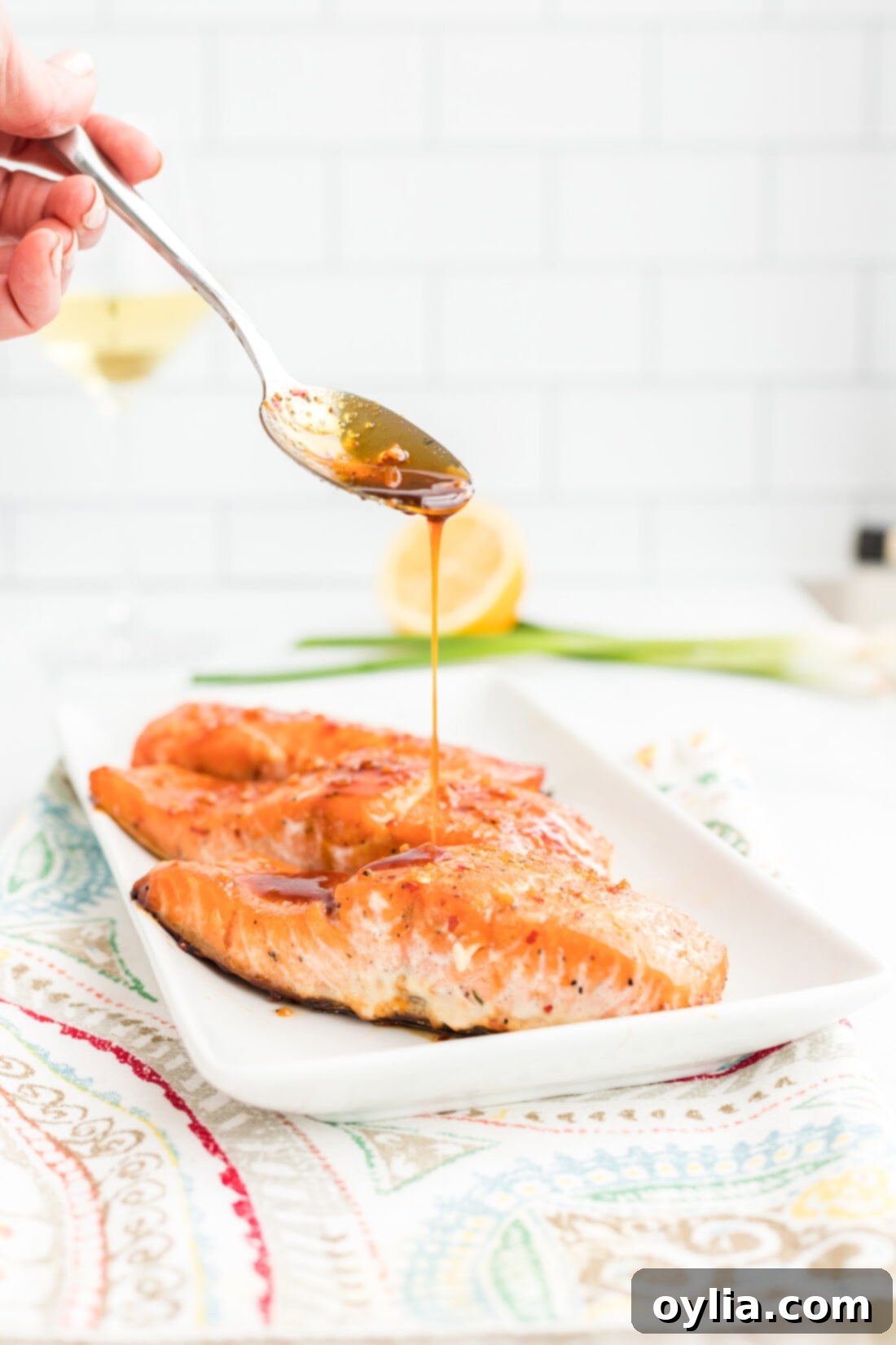 Drizzling sauce on Pan-Seared Maple Soy Salmon fillets