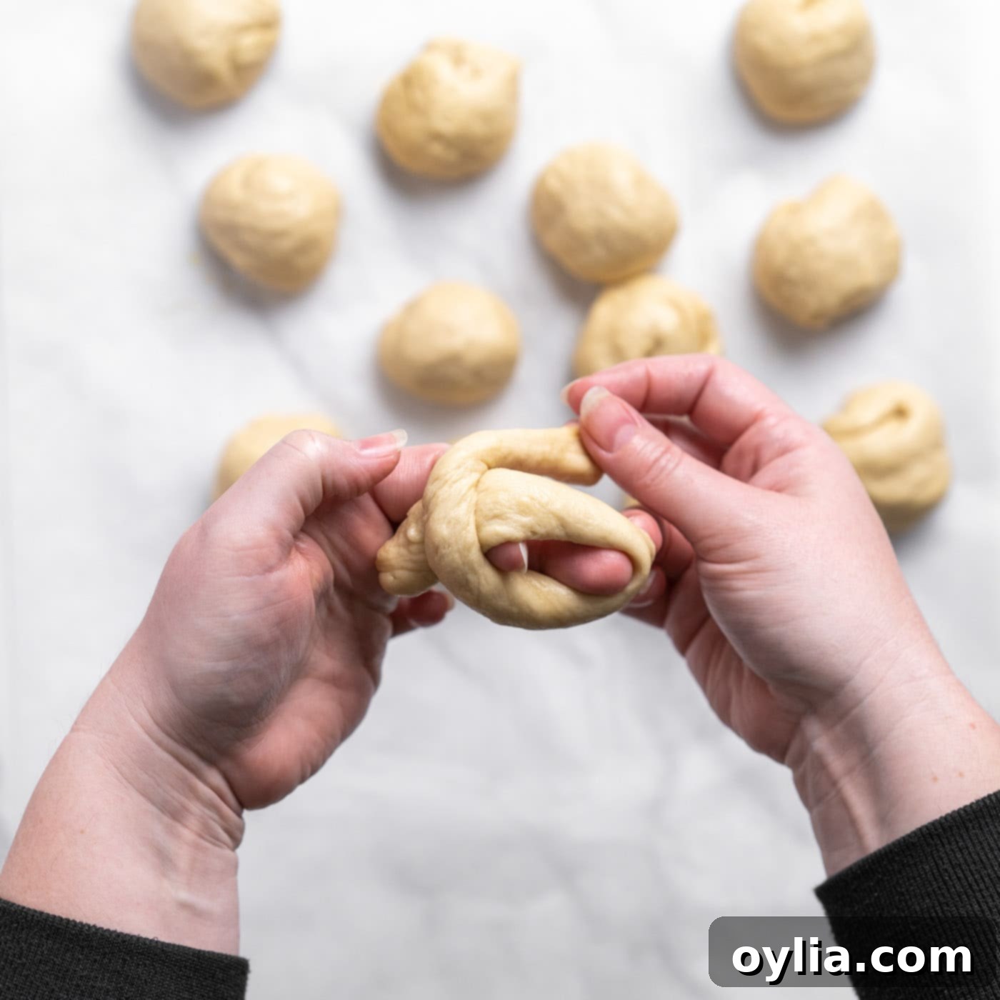 tying dough into a knot shape
