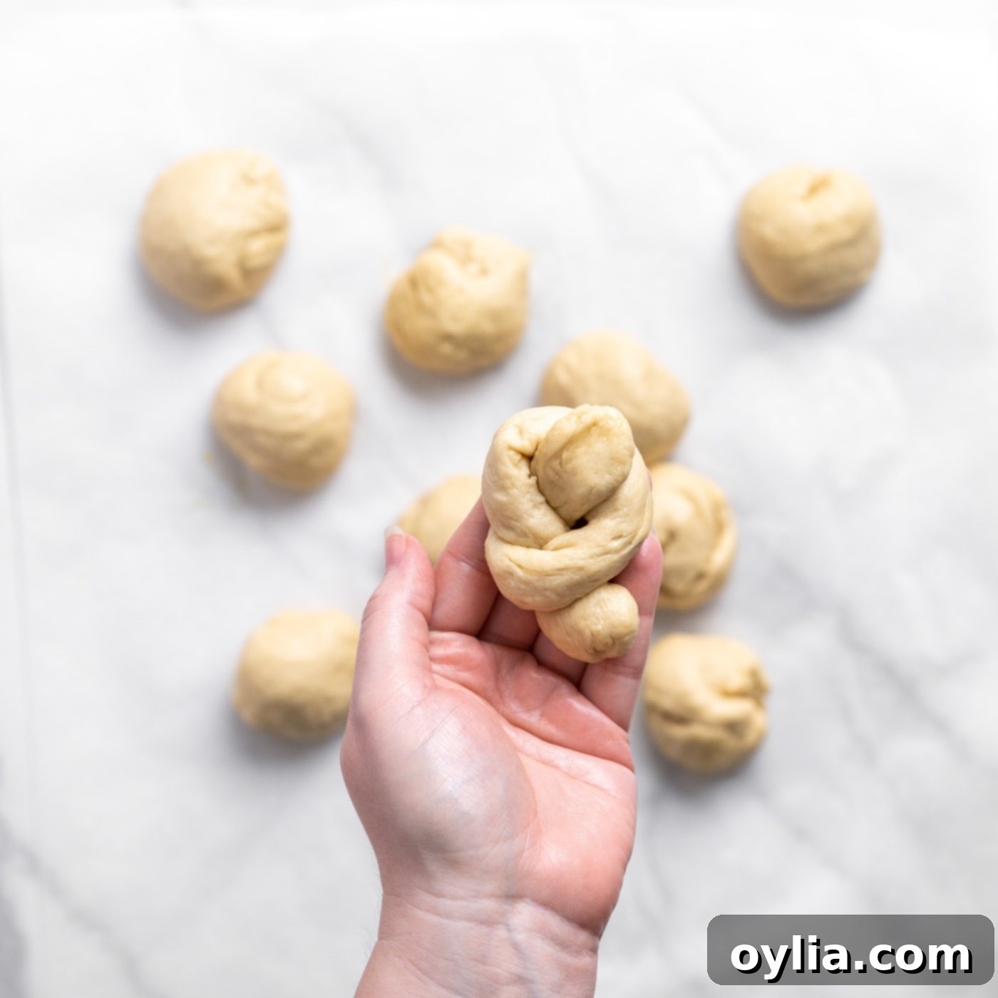 shaped garlic knot dough in hand