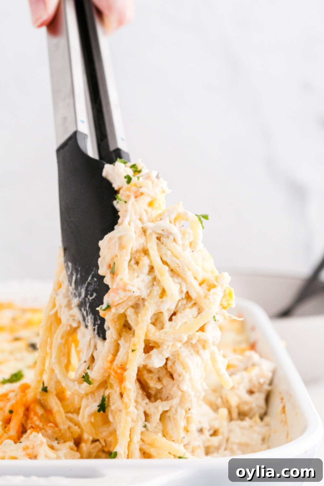 tongs lifting Chicken Tetrazzini