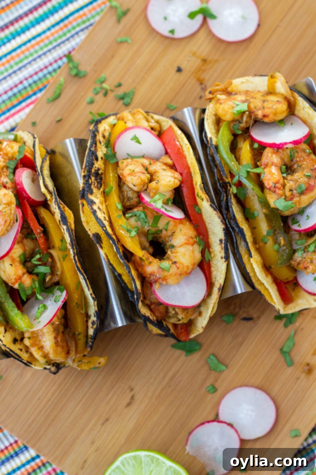 Close-up of shrimp fajitas wrapped in warm tortillas, garnished with cilantro and lime