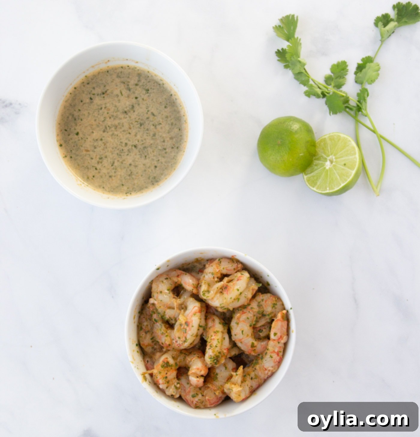 Raw shrimp marinating in a bowl with fajita seasoning, lime, and soy sauce