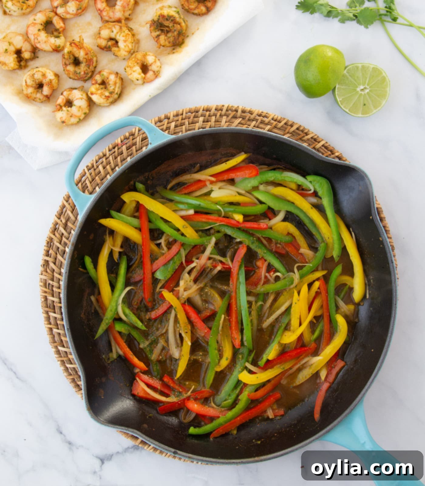 Colorful bell peppers and onions sizzling in a skillet, creating a aromatic base for fajitas