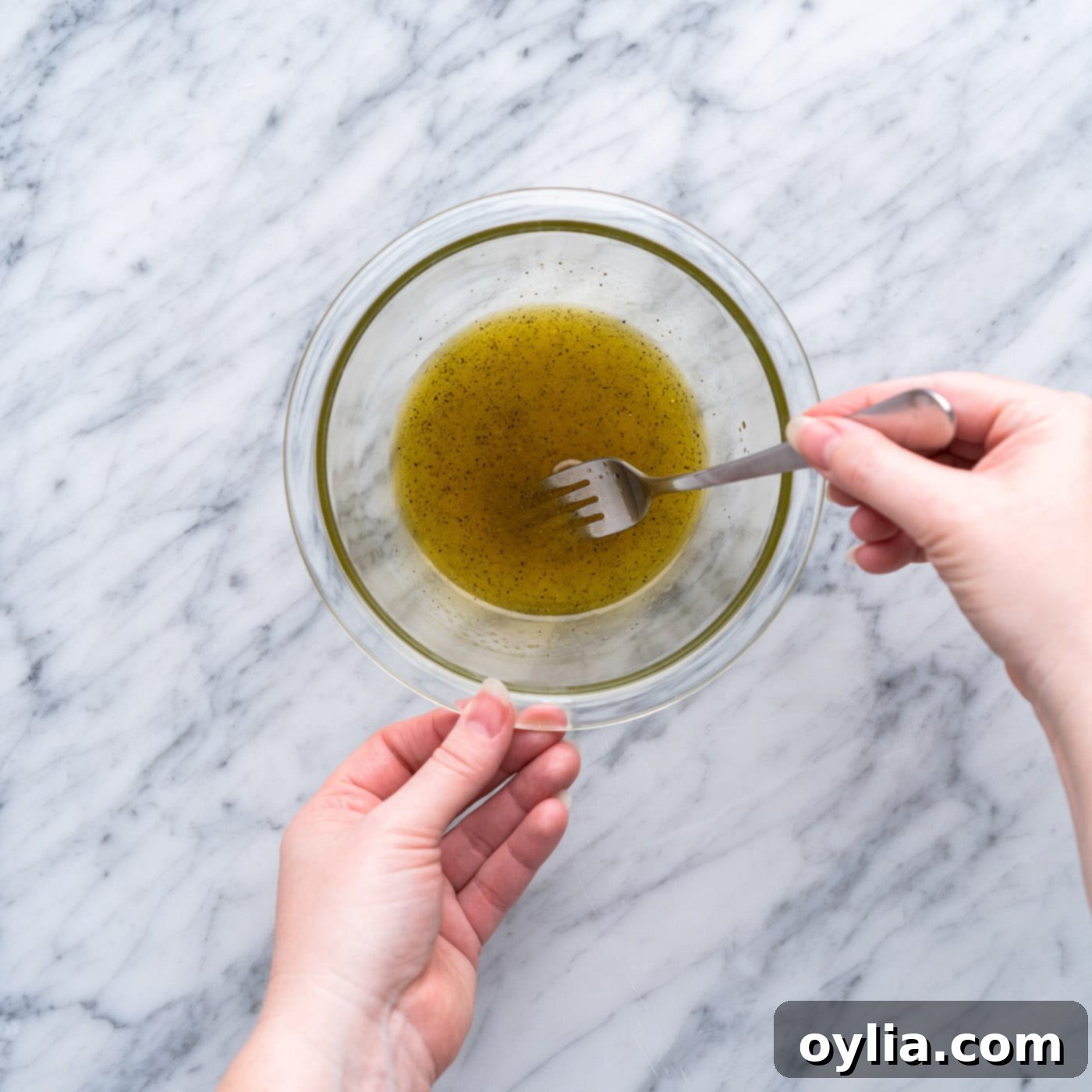 whisking vinaigrette in a small bowl