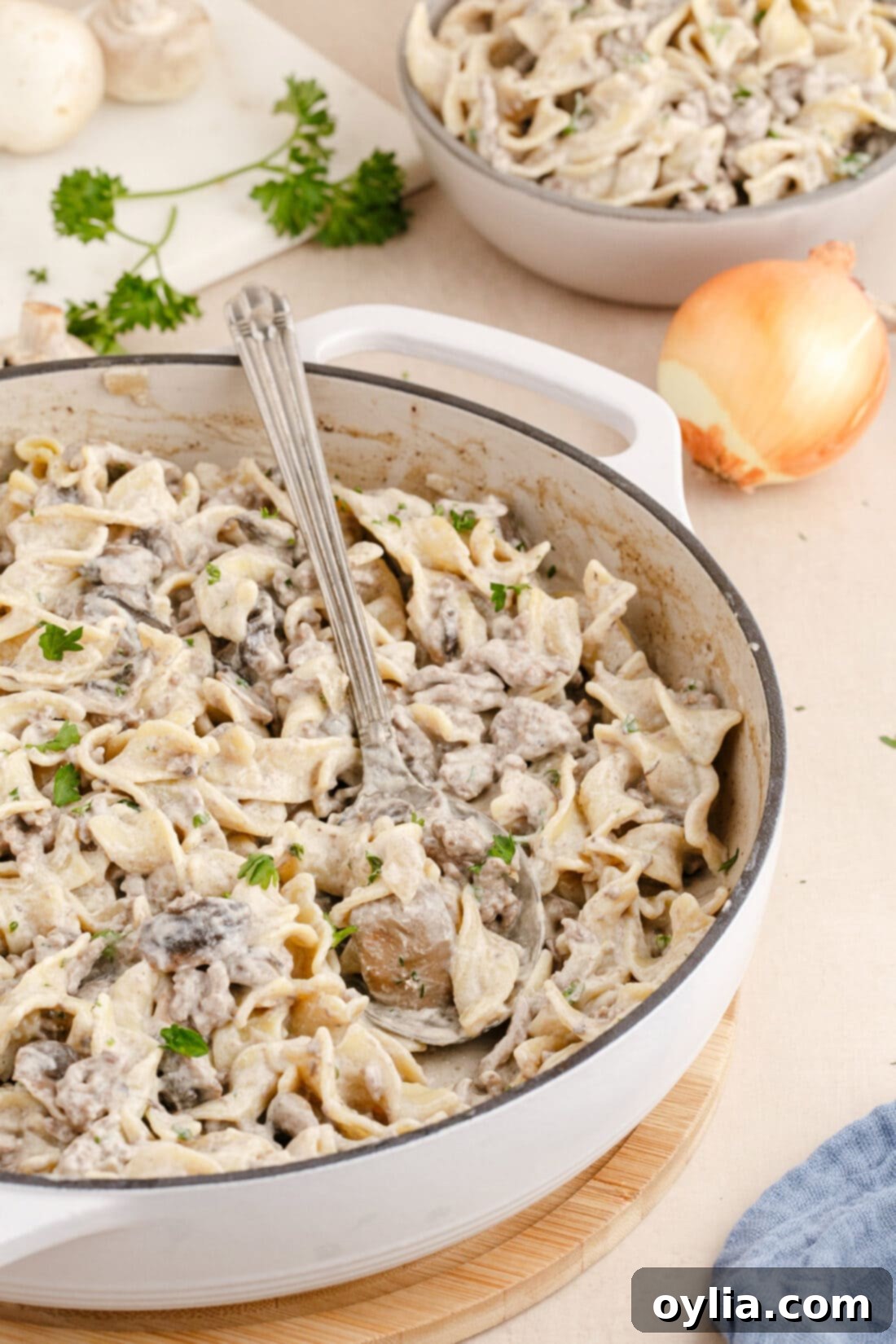 Ground Beef Stroganoff in a large skillet with a serving spoon