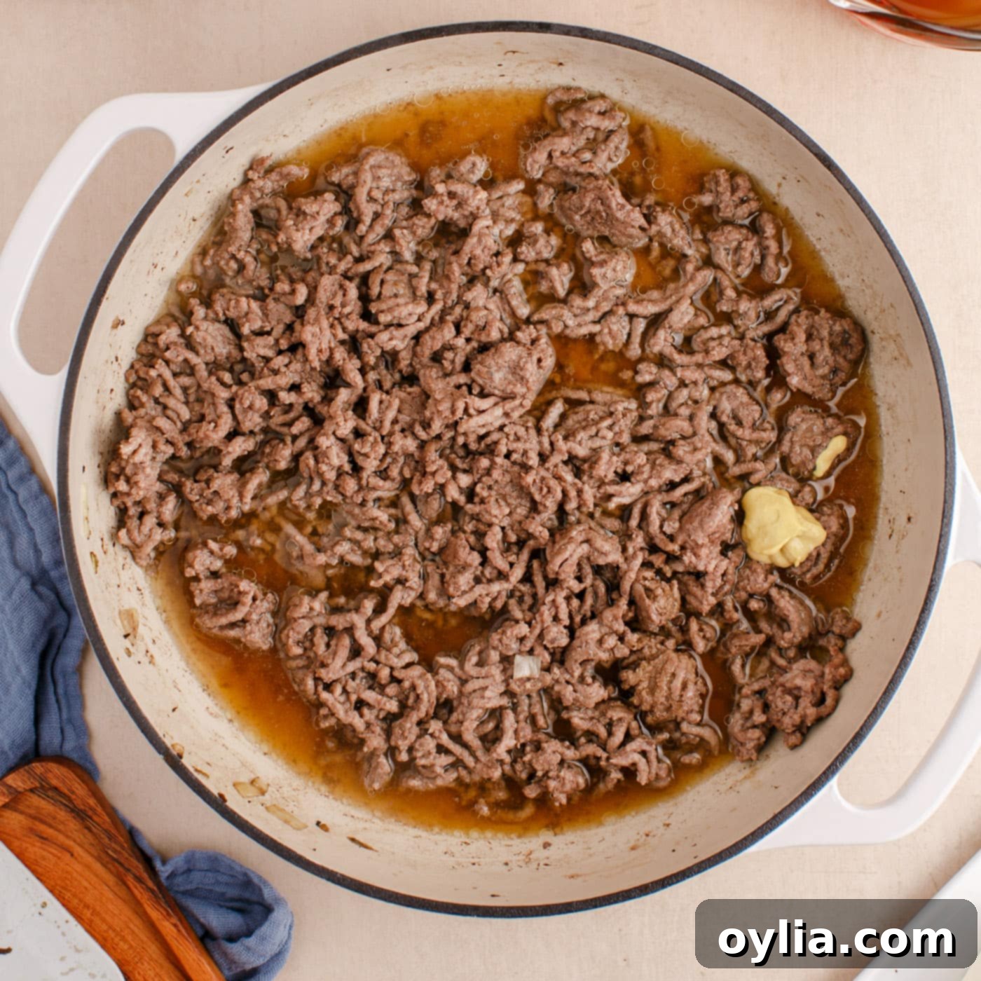 Dijon, Worcestershire, beef broth, and browned ground beef in a skillet