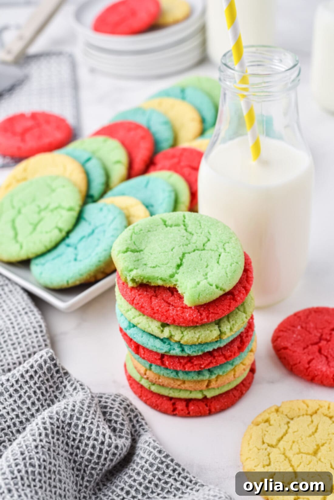 stack of Jello Cookies with a plate of cookies in back