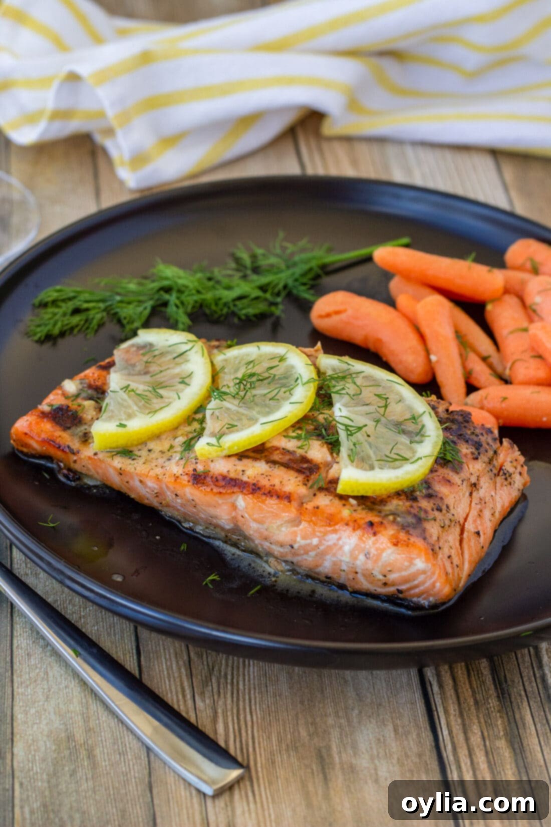 Lemon Salmon with carrots on plate, showcasing a perfectly grilled fillet alongside vibrant carrots.