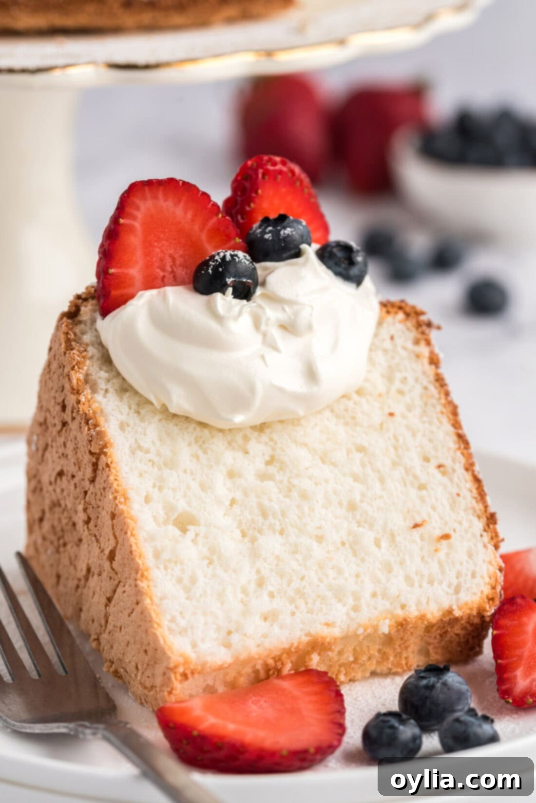 Heavenly Homemade Angel Food Cake 2 Slice of Angel Food Cake topped with whipped cream and fresh berries