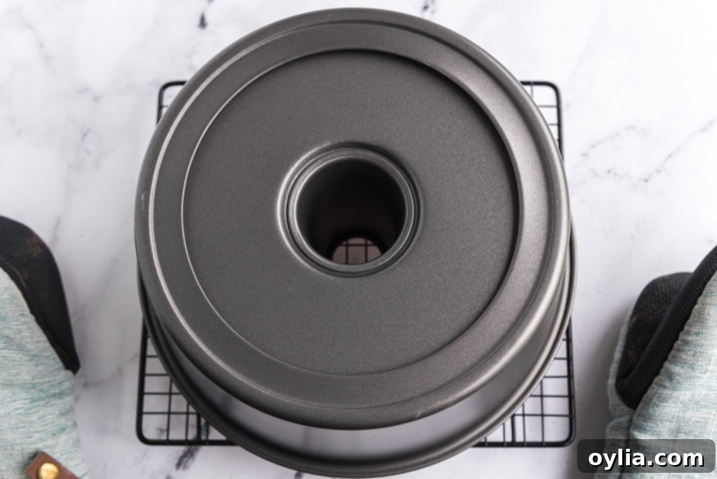 inverted angel food cake pan cooling on a wire rack