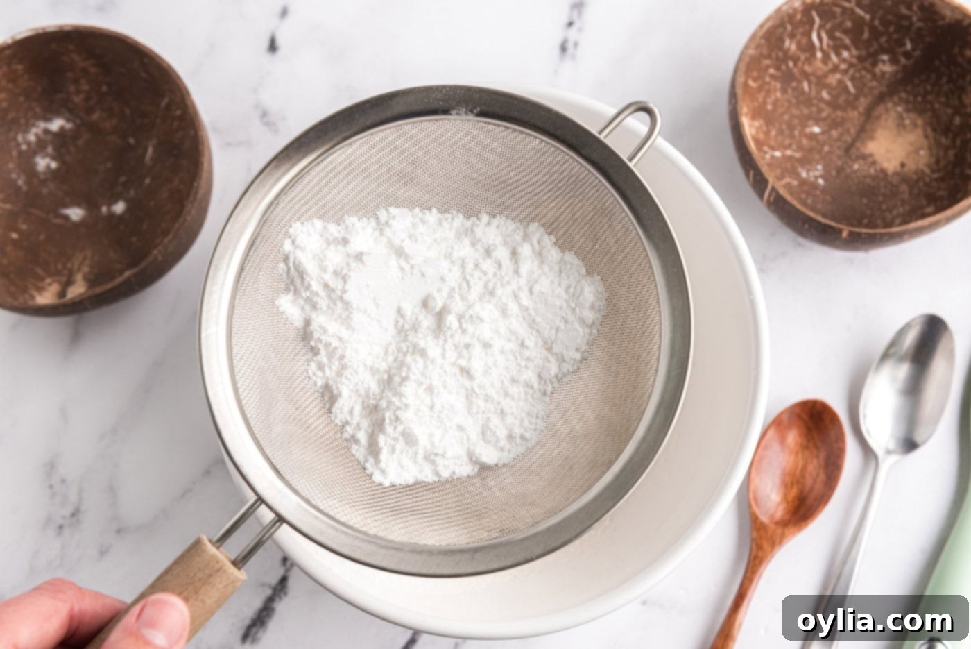 sifting powdered sugar and flour into a bowl