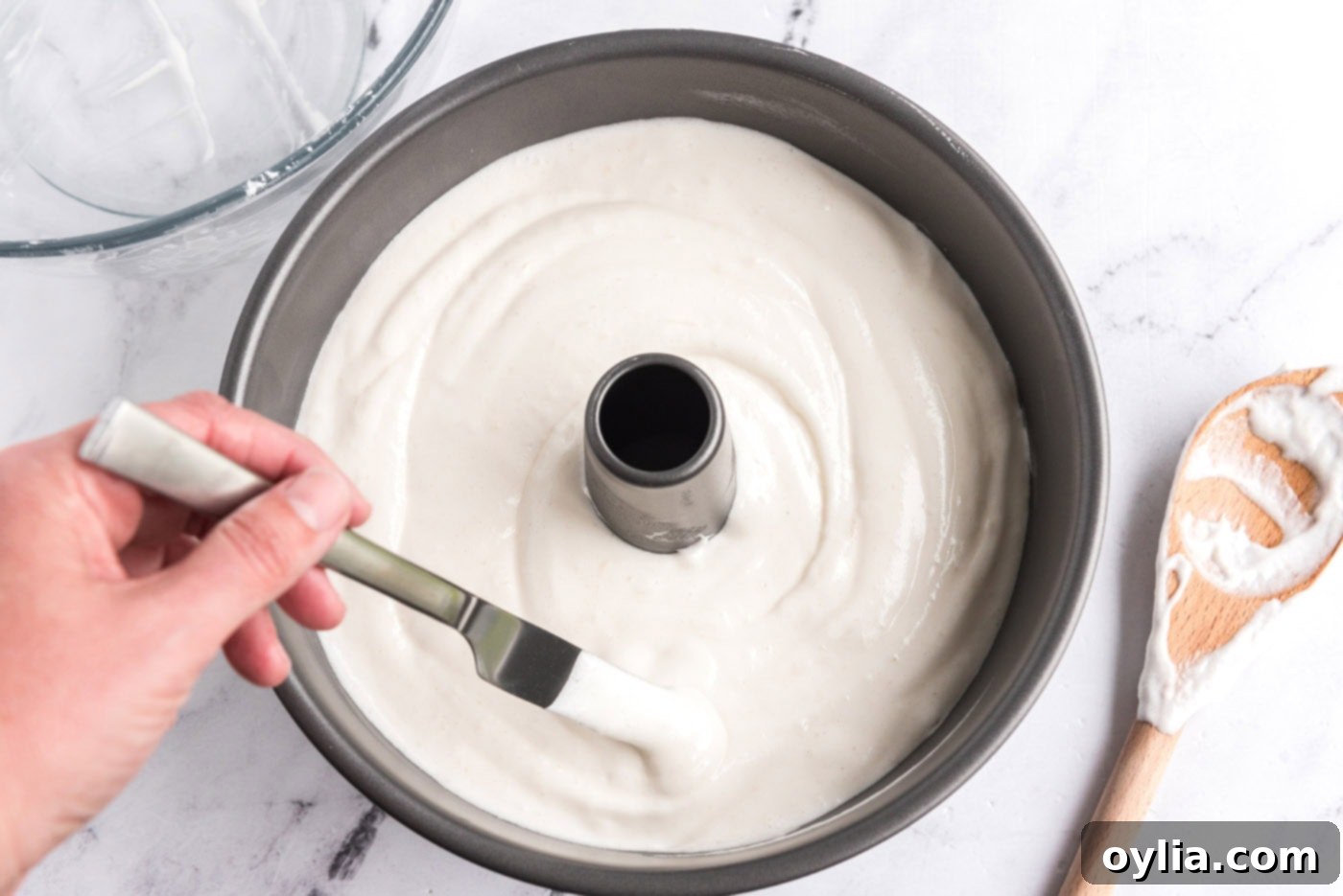 removing air pockets from angel food cake batter in tube pan with a butter knife