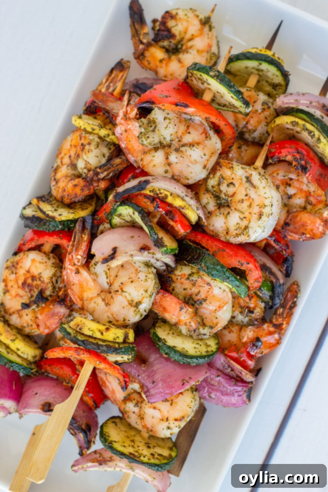 A platter of beautifully arranged grilled Shrimp Kabobs, ready to serve.