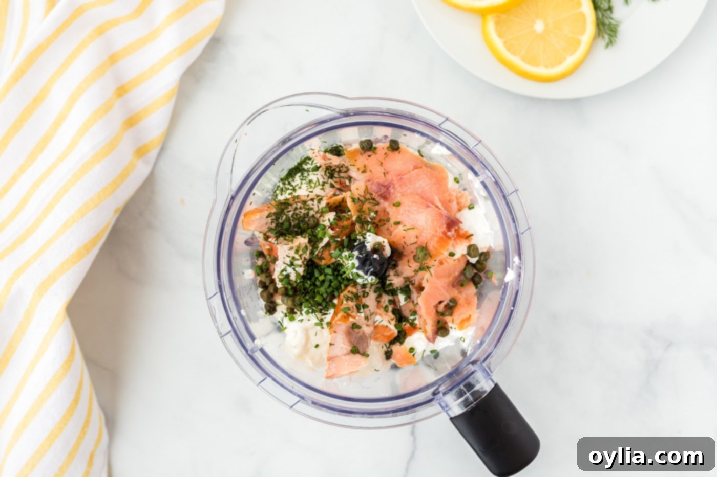 Smoked salmon dip ingredients in a food processor, ready for blending.
