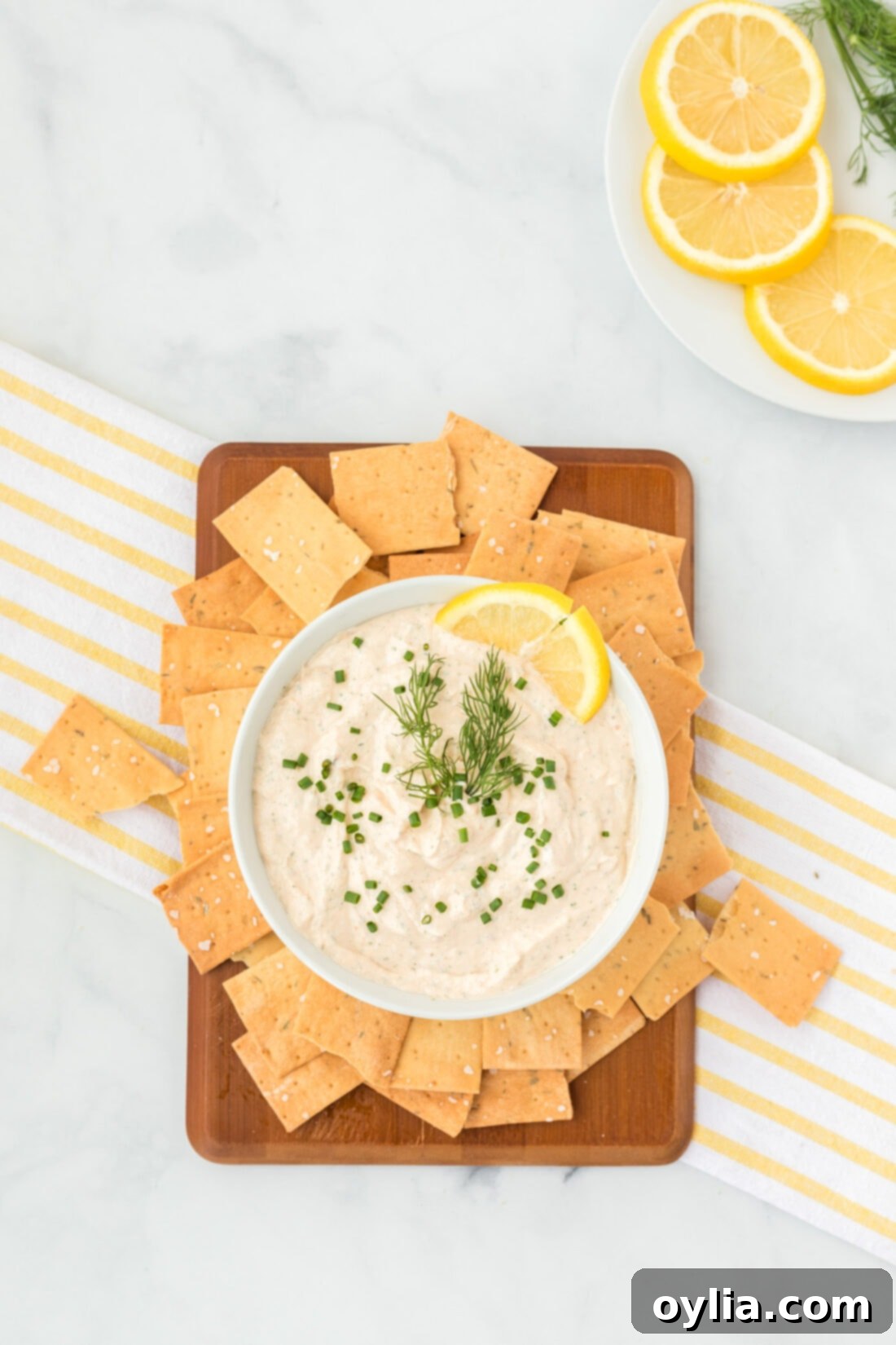 Gourmet Smoked Salmon Dip 7 A bowl of Smoked Salmon Dip served on a small wooden cutting board, ready for entertaining.