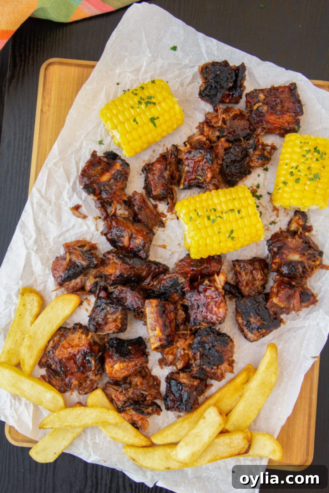 Rib Tips with fries and corn on cutting board