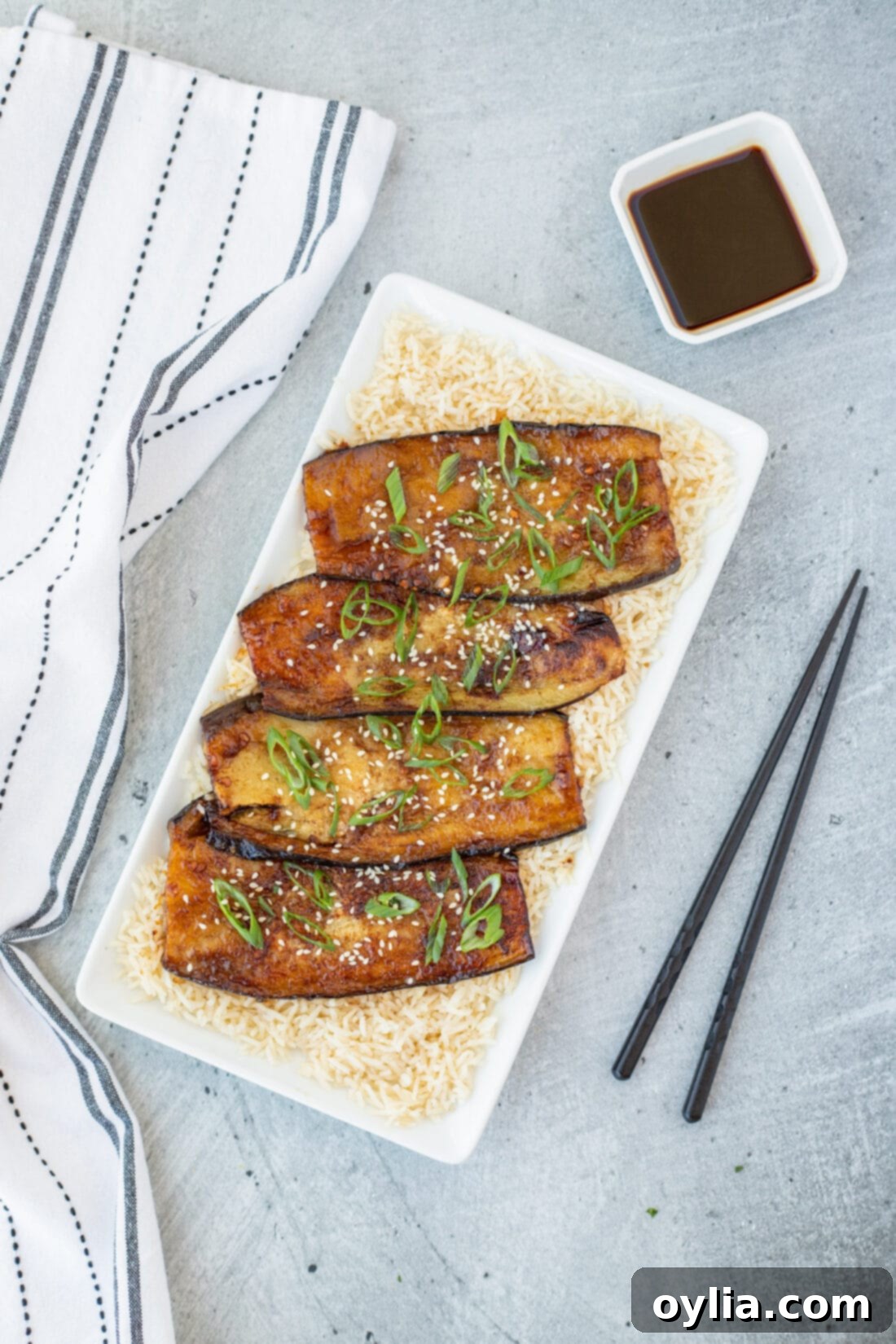 Soy Glazed Eggplant over rice on a plattter