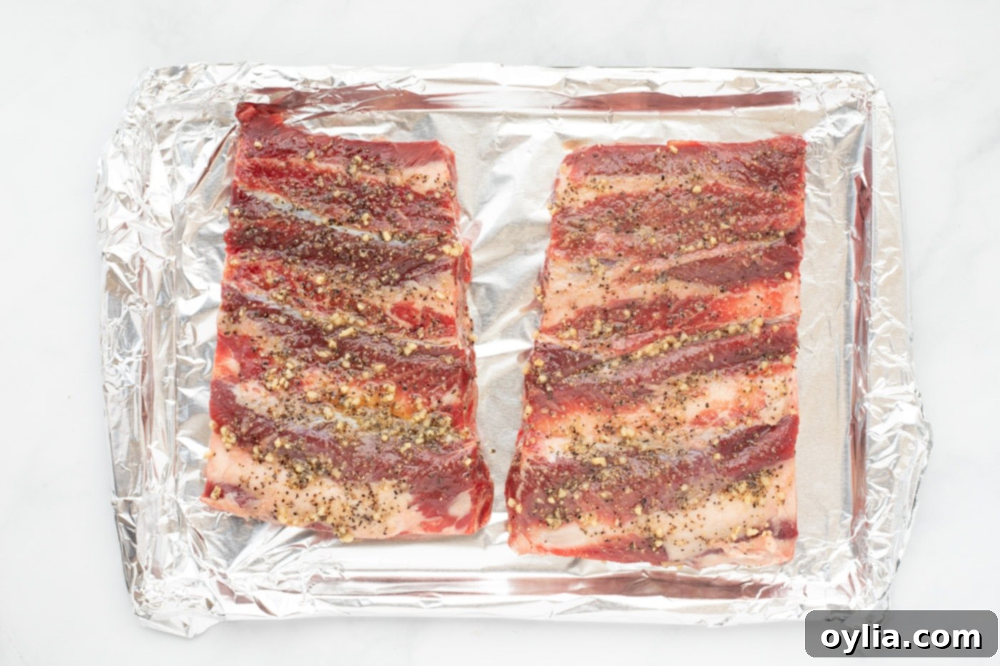 beef chuck riblets on a baking sheet