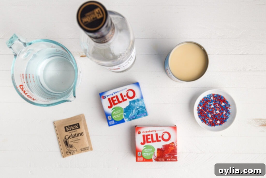Ingredients laid out for making 4th of July Jello Shots, including jello packets, vodka, and condensed milk