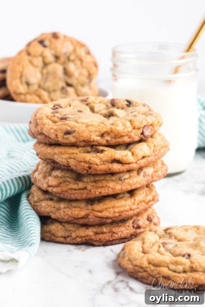 Big Soft Chocolate Chip Cookies AmandasCookin.com Stack of large, soft chocolate chip cookies next to a glass of milk