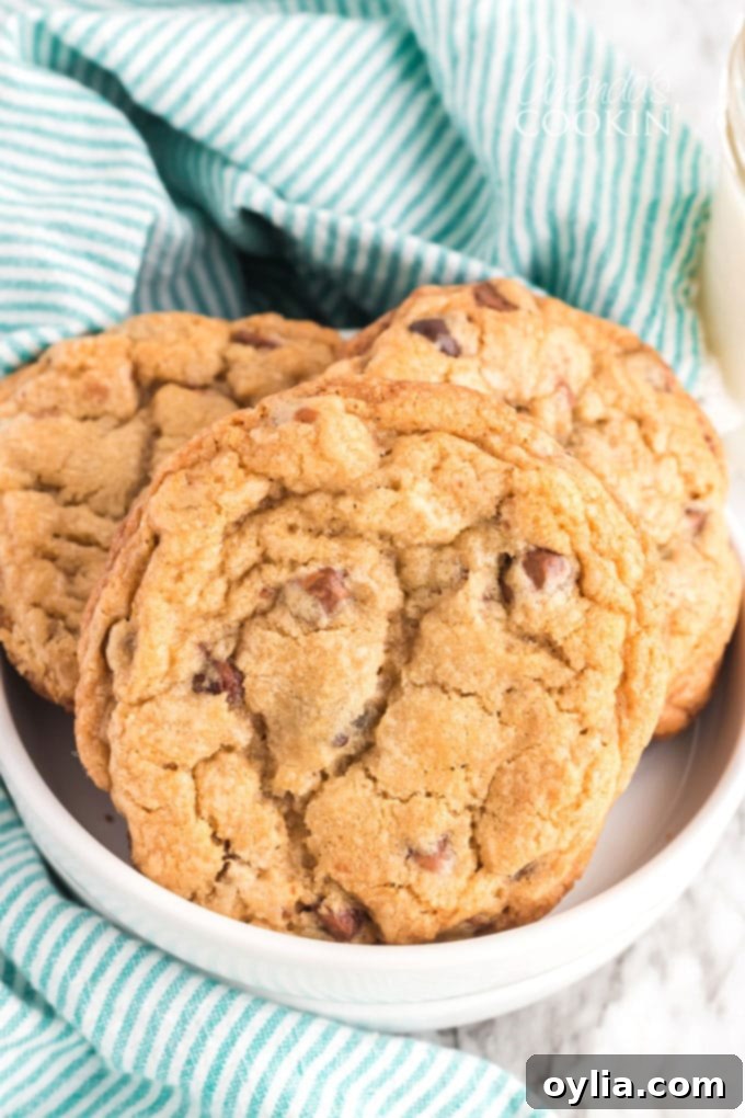 Big Soft Chocolate Chip Cookies AmandasCookin.com Freshly baked jumbo chocolate chip cookies piled in a rustic bowl
