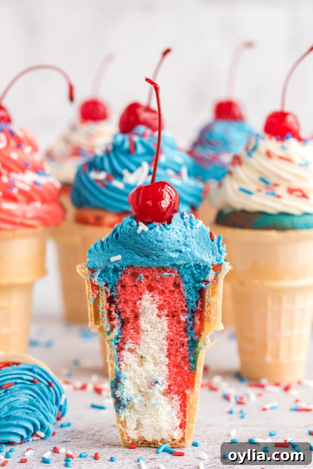 Patriotic Ice Cream Cone Cupcakes cut in half, revealing red, white, and blue cake layers