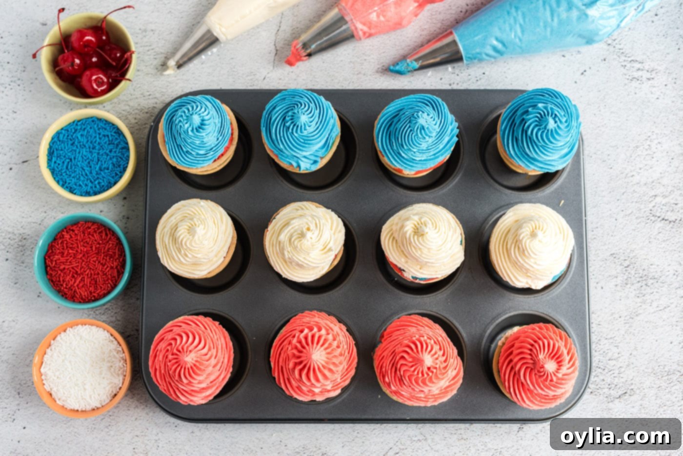 red, white, and blue ice cream cone cupcakes being frosted
