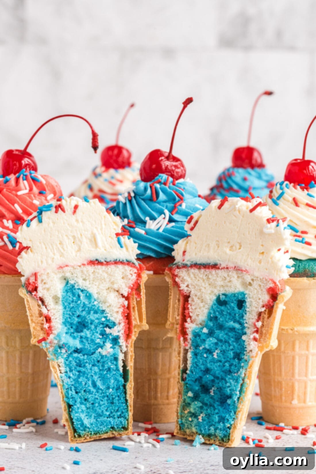 Patriotic Ice Cream Cone Cupcakes sliced in half, showing distinct red, white, and blue cake layers