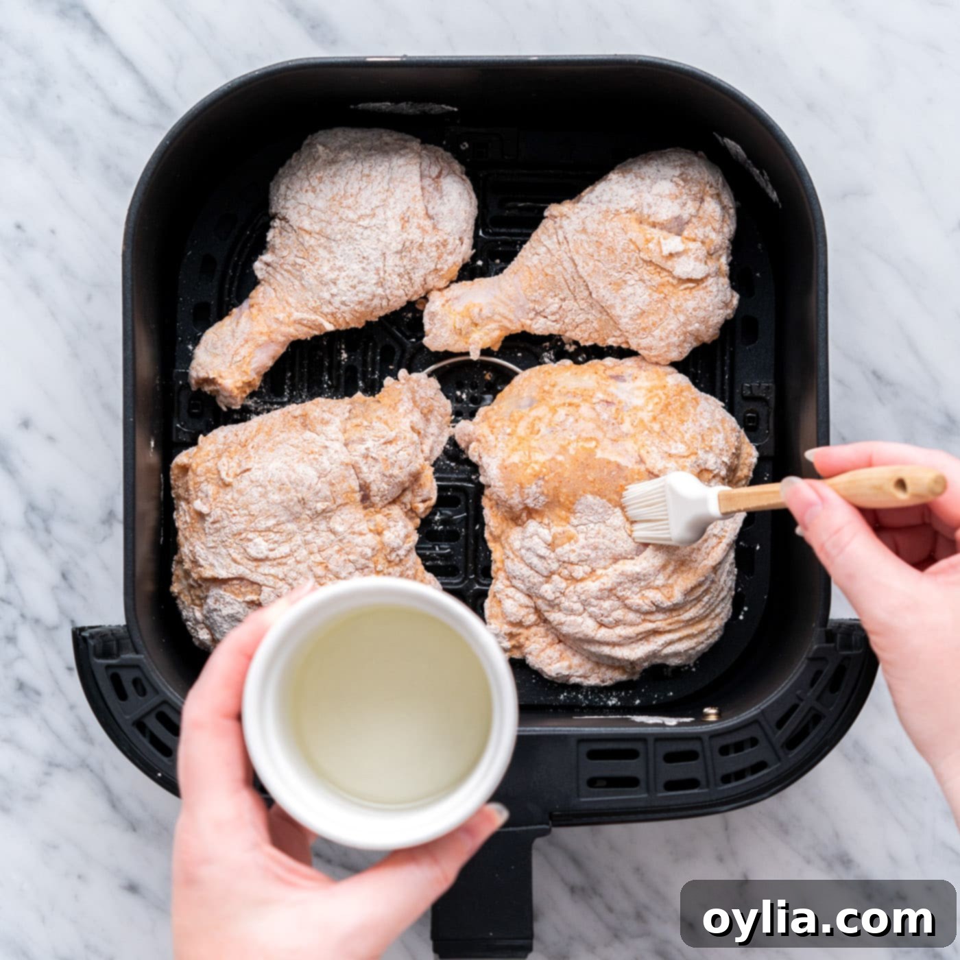 brushing dredged chicken with oil