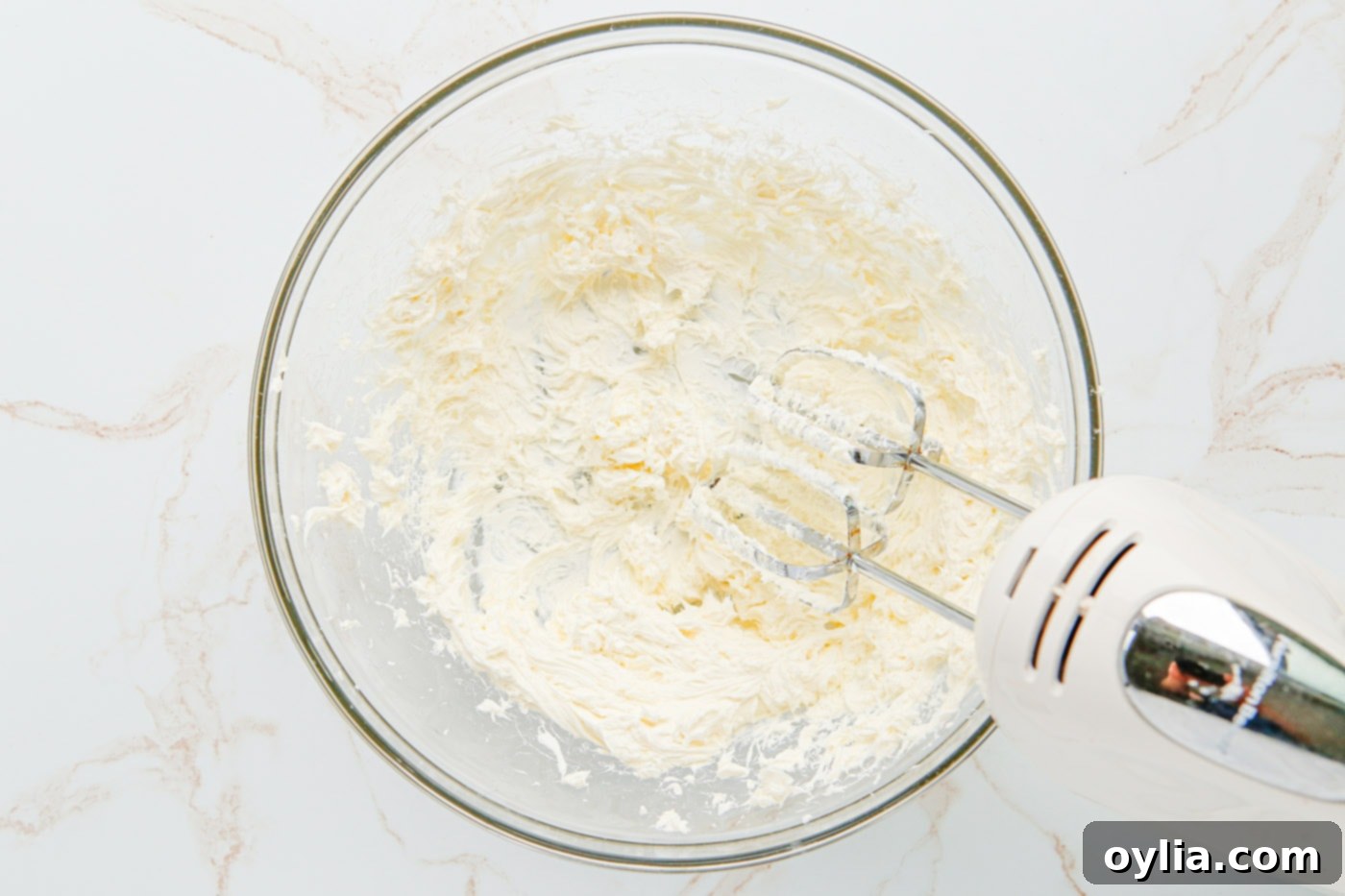 Blended cheesecake mixture in a bowl, smooth and fluffy.
