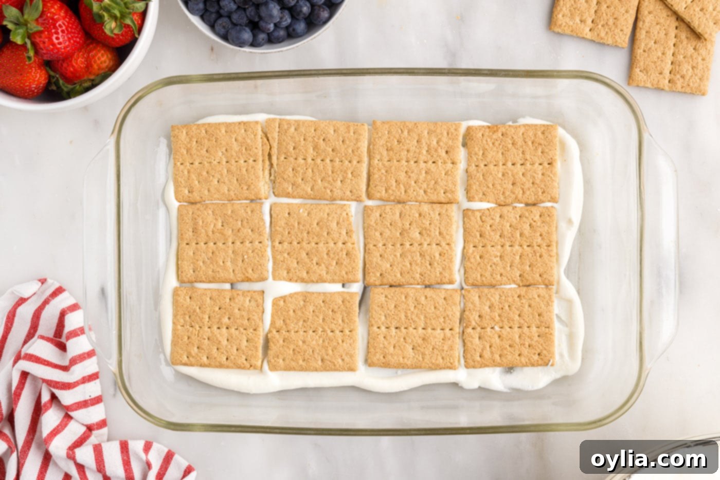 graham crackers layered on top of cool whip pudding mixture