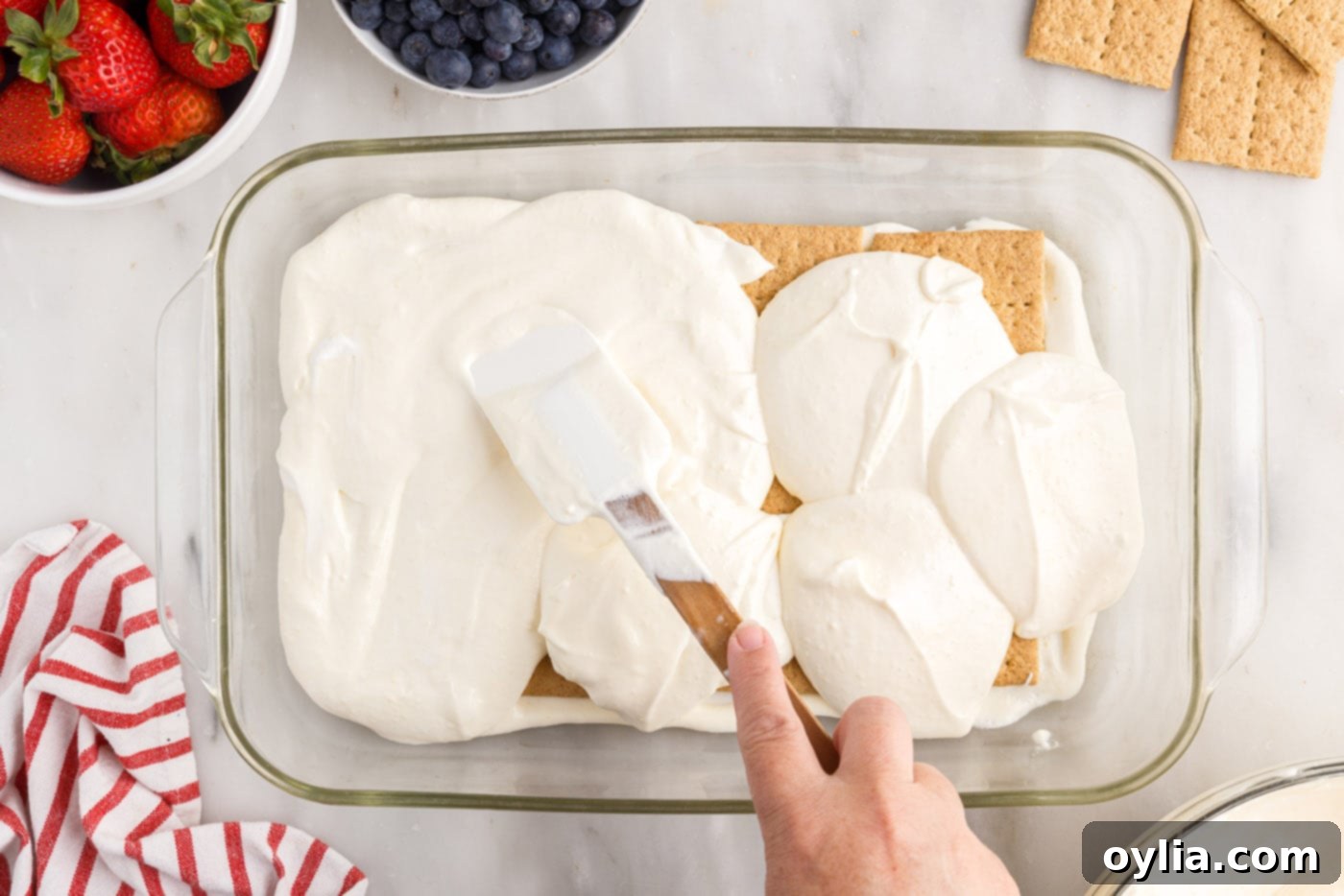 spreading pudding mixture over graham crackers