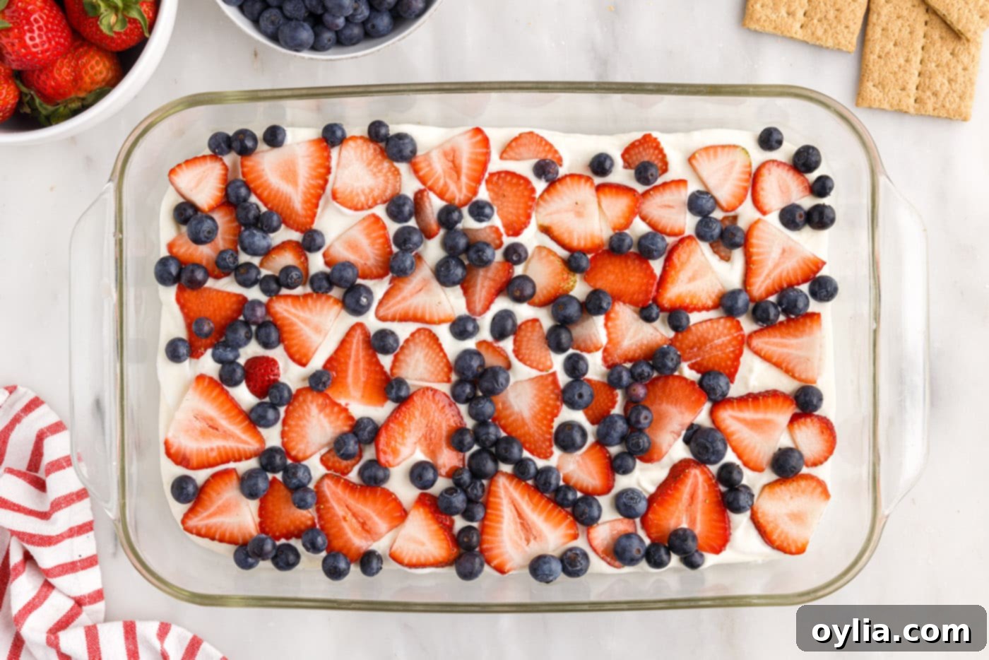 layer of strawberries and blueberries over cream cheese pudding mixture